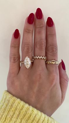 a woman's hand with two rings on it and one ring in the middle