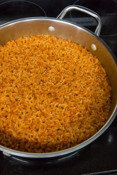 a pan filled with rice sitting on top of a stove