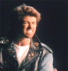 a man wearing a leather jacket and smiling