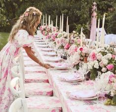 a long table is set with pink and white flowers