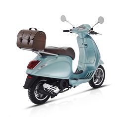 a blue scooter with a brown seat and luggage on it's back