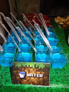 a table topped with plastic containers filled with water