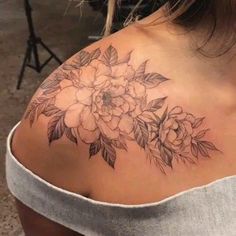 the back of a woman's shoulder with flowers on it