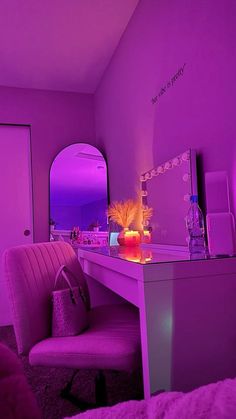 a purple room with a desk, chair and mirror