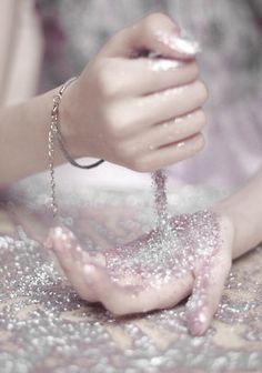 a woman is washing her hands with soap