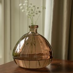 a vase with flowers in it sitting on a table