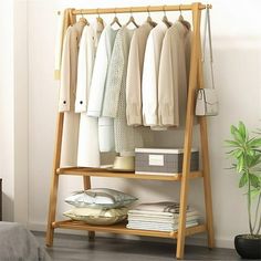 Discover the ultimate wardrobe organizer: our Bamboo Foldable Clothing Shelf. Made from sustainable bamboo, this stylish shelf effortlessly declutters your space while adding a touch of natural elegance. Perfect for small spaces or walk-in closets, its foldable design offers convenient storage without compromising style. Elevate your organization and embrace eco-friendly living with our Bamboo Foldable Clothing Shelf today. Features Sustainable Bamboo Construction: Durable and eco-friendly, our Portable Clothes Rack, Wood Shoe Storage, Hall Stand, Scandinavian Color, Wood Shoes, Clothes Rail, Hall Tree, Garment Racks, Clothes Rack