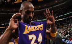 a basketball player is holding up his jersey