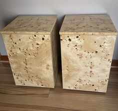 two large wooden boxes sitting on top of a hard wood floor next to each other