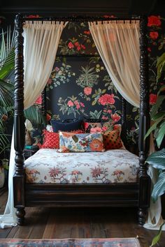 a canopy bed with floral wallpaper and curtains on the sides, in front of potted plants