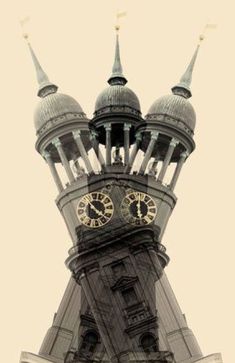 a large clock tower with two clocks on each of it's sides