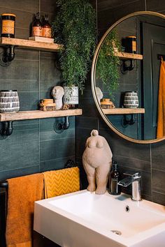 a bathroom sink sitting under a round mirror