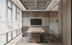 an empty conference room with chairs and a large table in front of a flat screen tv