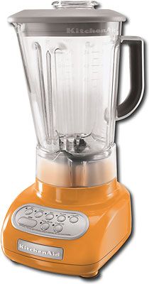 an orange kitchen aid blender on a white background