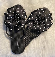 A pair of Old Navy flip flops decorated with a black grosgrain ribbon adorned with white polka dots. Ribbons are hand sewn to the shoe by me!! Super cute and fun!! Great for poolside or the beach, adorable for anywhere!! Three loops of one and a half inch ribbon made into a pinwheel bow that measures approximately 5 inches wide. Ends are heat sealed for no fraying. I'll be coming out with more colors soon so come back and visit!! Thank you for stopping by!! Custom requests are always welcome. Pl Casual Summer Flip Flops With Bow, Summer Bow Flip Flops With Open Toe, Summer Beach Flip Flops With Bow, Summer Bow Sandals For Beach, Adjustable Bow Sandals For Beach, Black Bow Sandals For Summer, Fun Black Flip Flops For Beach, Adjustable Bow Sandals For Vacation, Fun Black Flip Flops For Summer