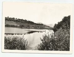 an old black and white photo of a lake