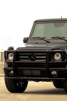 a black and white photo of a mercedes g - class