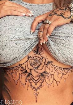 a woman with a rose tattoo on her stomach