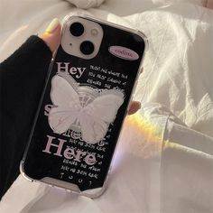 a person holding a cell phone case that has a butterfly design on the front and back