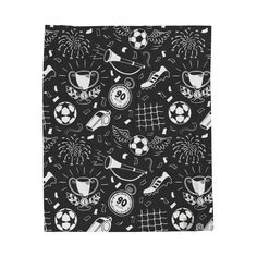 a black and white pattern with soccer related items on the front, along with fireworks