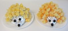 two plates with food shaped like hedgehogs on them