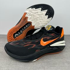 a pair of black and orange nike shoes