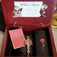 the beauty and the beast watch is in its gift box, next to other items