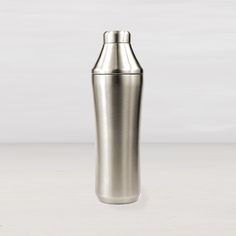 a stainless steel cocktail shaker on a white background