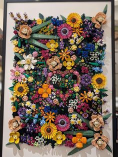 an art piece made out of flowers on display