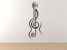 an acoustic guitar wall sticker on the wall in a room with hardwood flooring