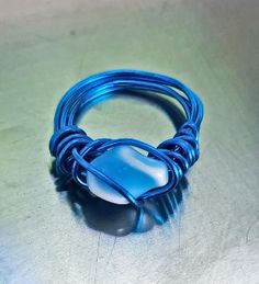 a blue wire ring sitting on top of a table