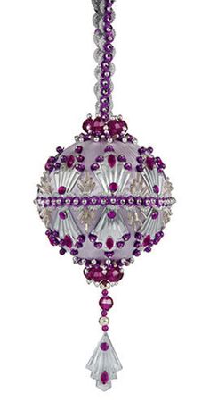 a purple beaded ornament hanging from a chain