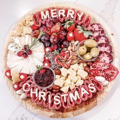 a platter filled with lots of different types of food and the words merry on it