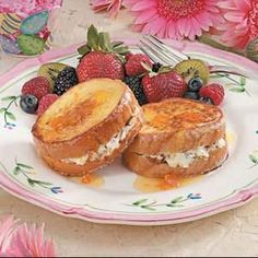 two pieces of toast on a plate with fruit