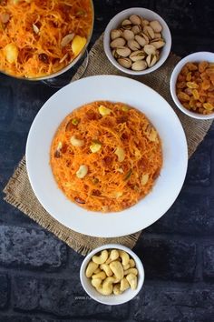 three bowls filled with food sitting on top of a table