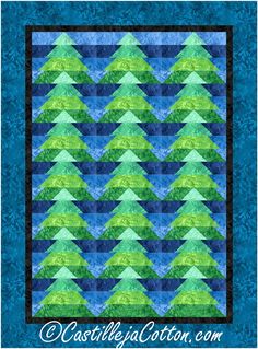 a blue and green quilted wall hanging with an image of trees in the background