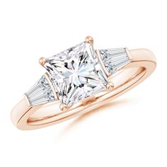 a rose gold ring with two princess cut diamonds on the shoulders and three baguets