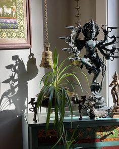 a table topped with lots of statues and plants