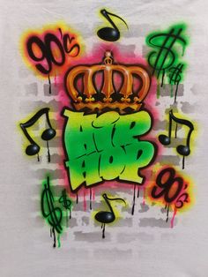 a white t - shirt with colorful graffiti on the chest and crown in the middle