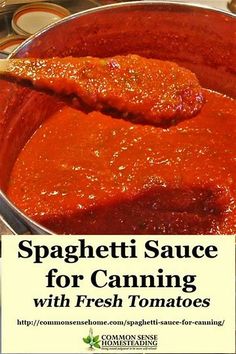 spaghetti sauce for canning with fresh tomatoes in a large metal pan on top of a stove