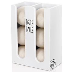 four balls in a white box with the words dryer balls written on each one