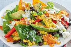 a white plate topped with salad and tortilla chips