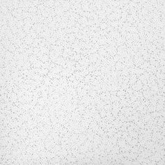 a white wall with black speckles on it