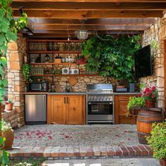 an outdoor kitchen with lots of plants growing on the wall