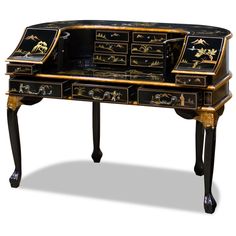 an antique black and gold desk with drawers