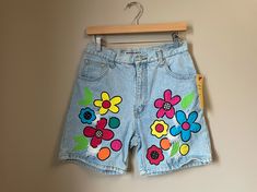 "Label * Dakota Blue | Decade * 1990s | Color * Blue/Multi Vintage light blue stonewash denim shorts. colorful patchwork appliqué flowers with distressed/frayed areas. high waist. Button front & zip fly closure. 5 pocket styling. Fabric content: 100% cotton ❉ Super cute 90s girl shorts! Modern size estimate: M/L (Tag reads a vintage size 13/14) ⦿ Waist: 29/30\" ⦿ Hips: 40\" ⦿ Rise: 12\" ⦿ Inseam: 7\" ⦿ Length: 17\" All measurements are taken flat. Condition: Excellent! ❉ this is a vintage it Multicolor Denim Jean Shorts For Spring, Spring Multicolor Denim Jean Shorts, 90s Inspired Denim Jean Shorts For Spring, Retro Cutoff Jean Shorts For Spring, 90s Style Cotton Jean Shorts For Spring, Multicolor Cutoff Jean Shorts For Spring, Spring Multicolor Cutoff Jean Shorts, Retro Blue Jean Shorts For Spring, Summer Cutoff Jean Shorts With Patches