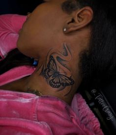 a woman with a butterfly tattoo on her neck