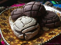 some cookies are on a plate with flowers