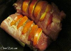 ham wrapped in bacon with orange slices on top