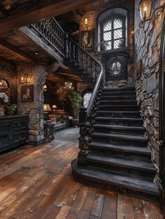 a large staircase leading up to the second floor in a stone and wood house with arched windows